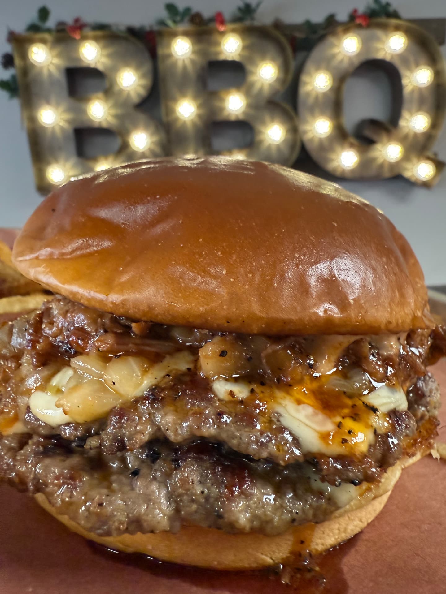 Burger of the week with caramelized onions beneath the BBQ marquee