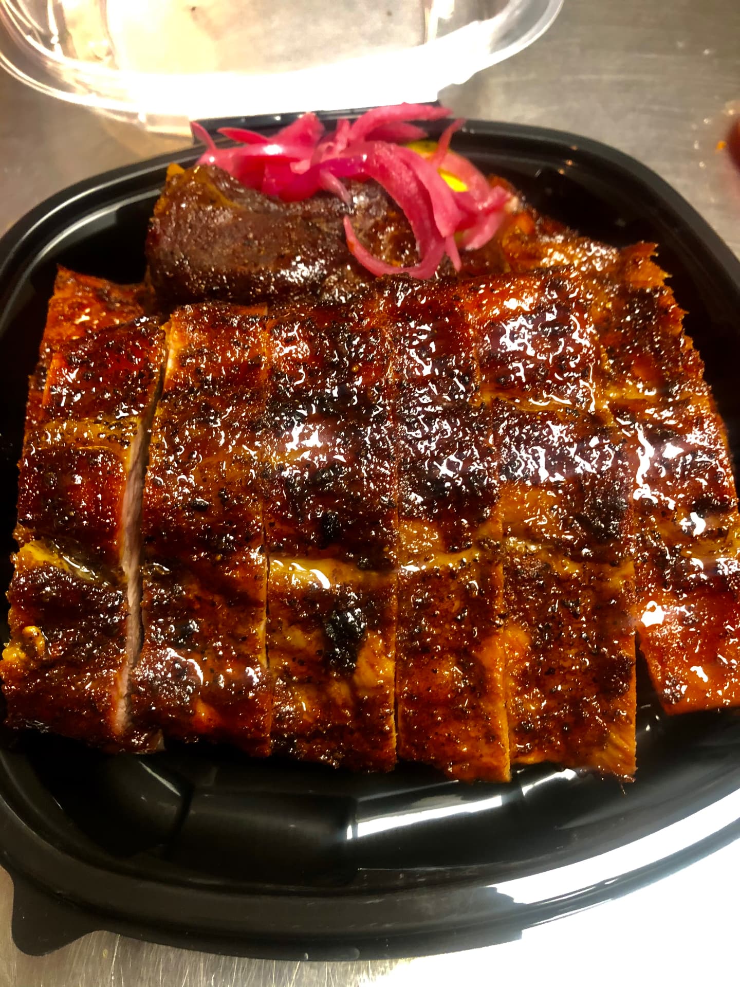 Glazed sliced ribs with pickled red onions