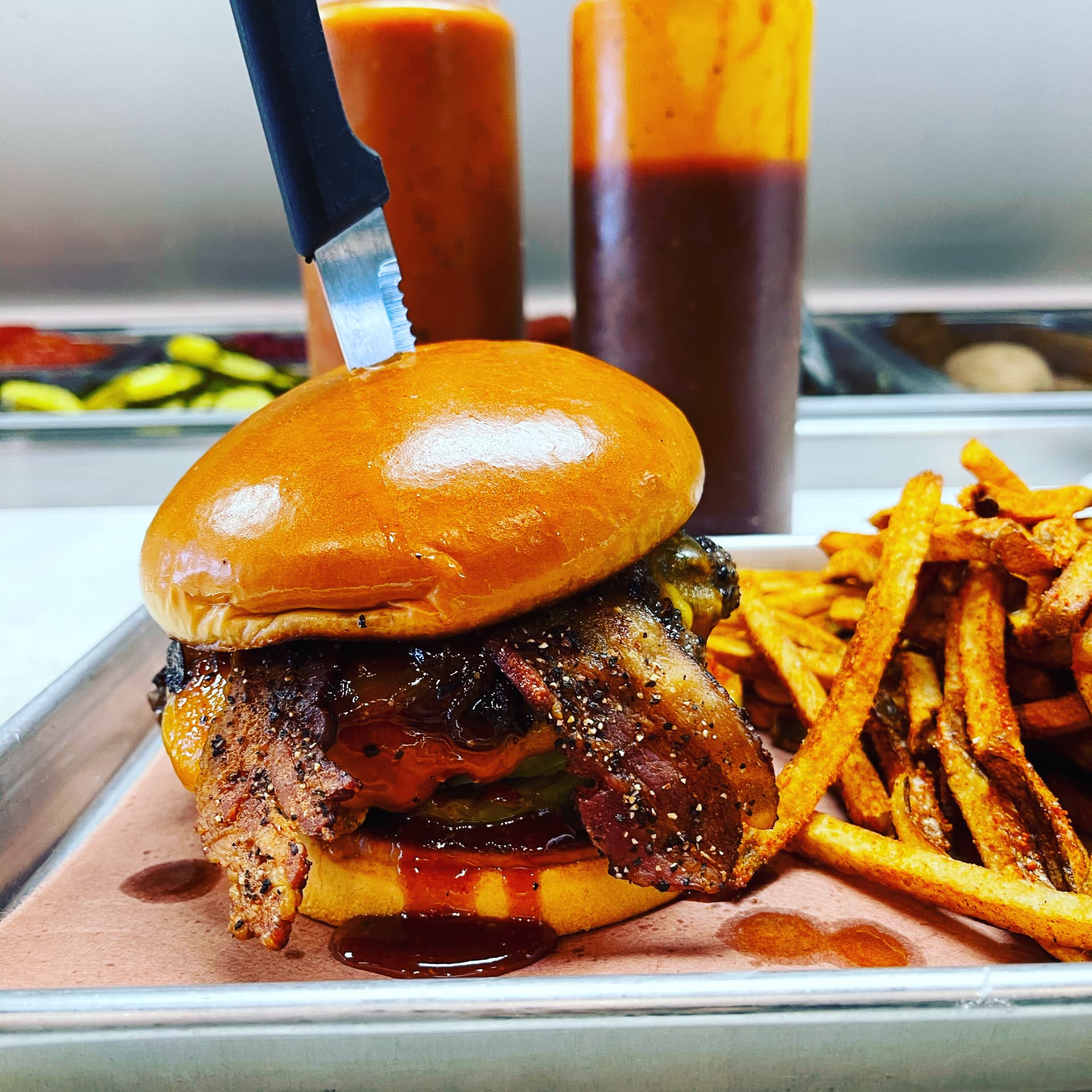 Sauced brisket sandwich with seasoned fries