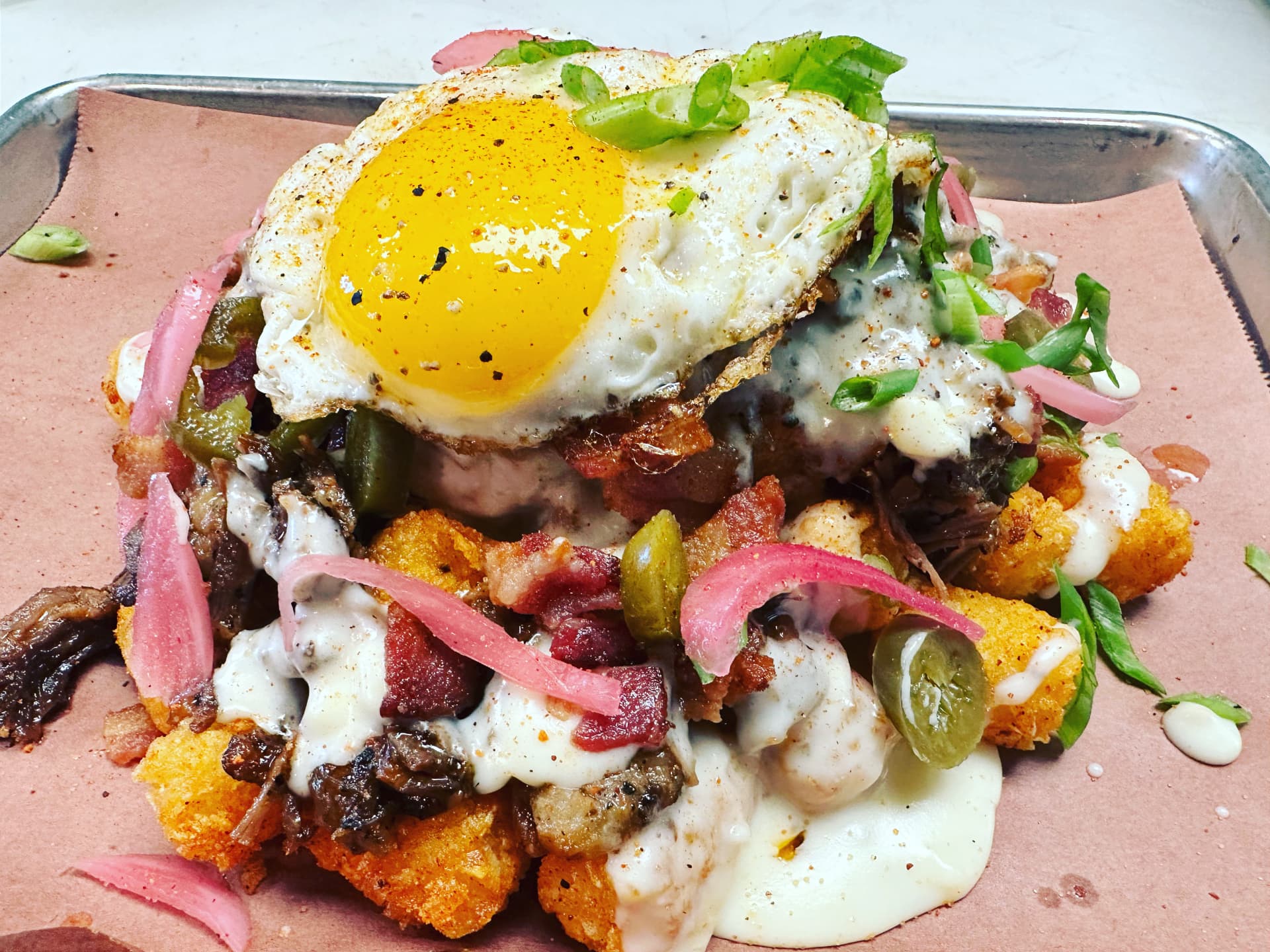 Loaded potatoes with smoked meat, bacon and a fried egg