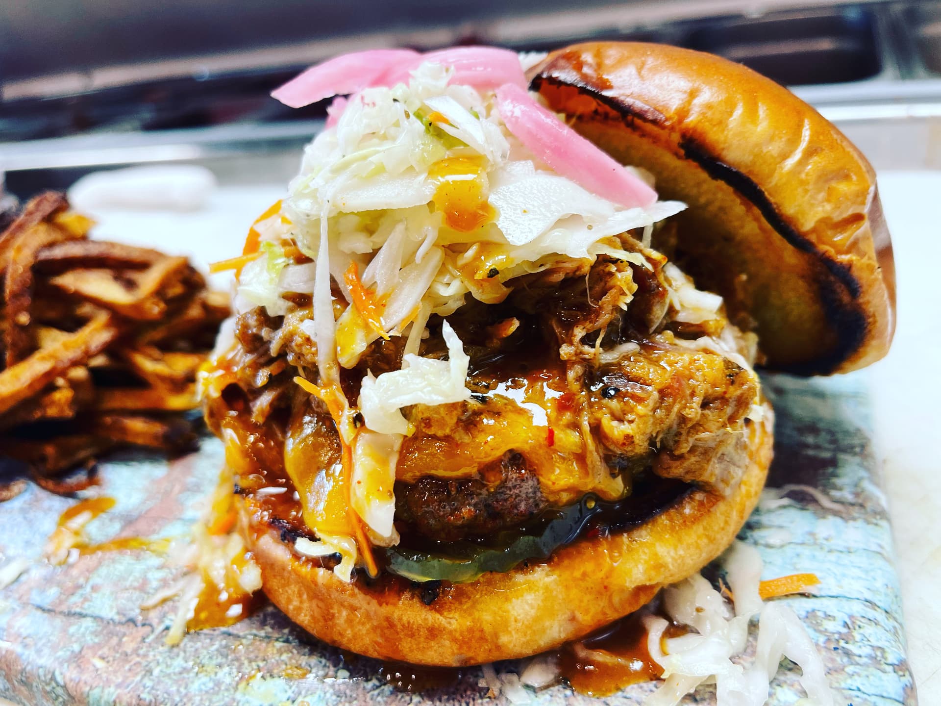 Barbecue burger piled with smoked meat and vinegar slaw