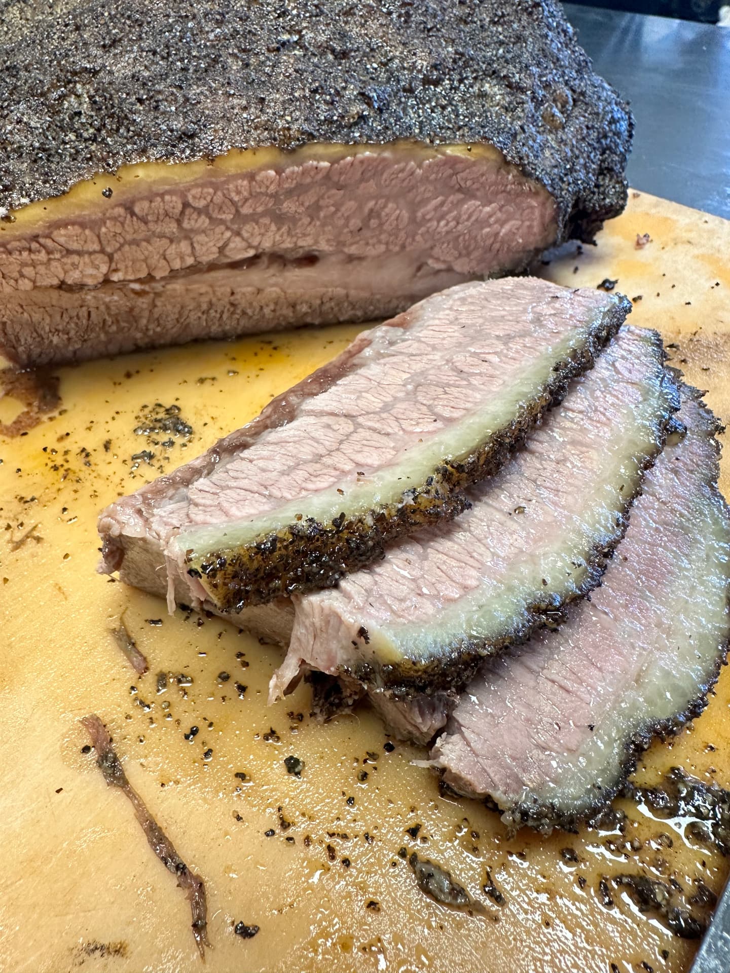 Fresh slices cut from a pepper-crusted smoked brisket