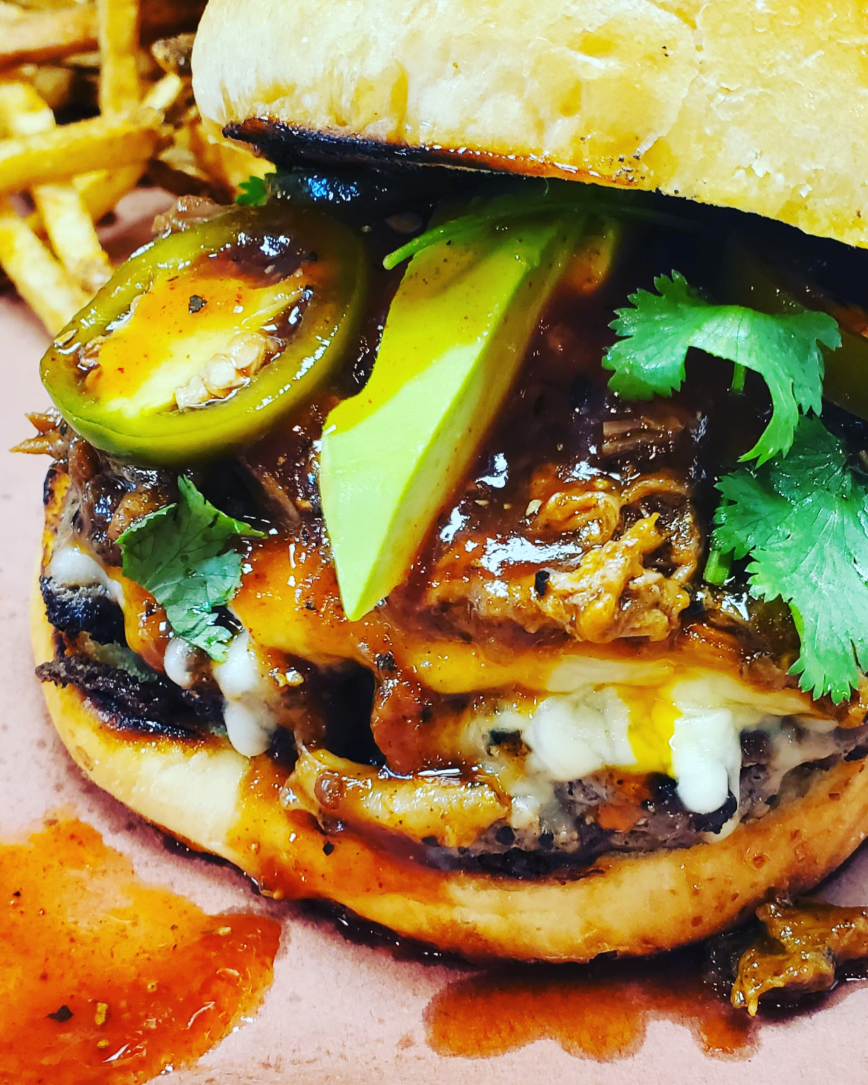 Barbecue burger with avocado, jalapeño and fresh cilantro