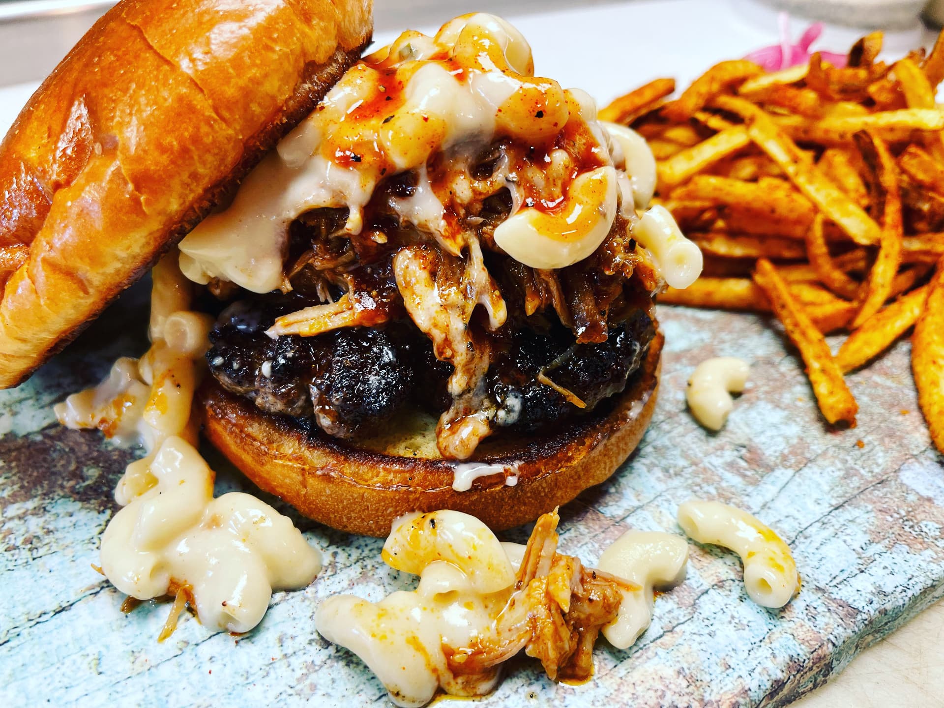 Barbecue burger piled with macaroni and cheese