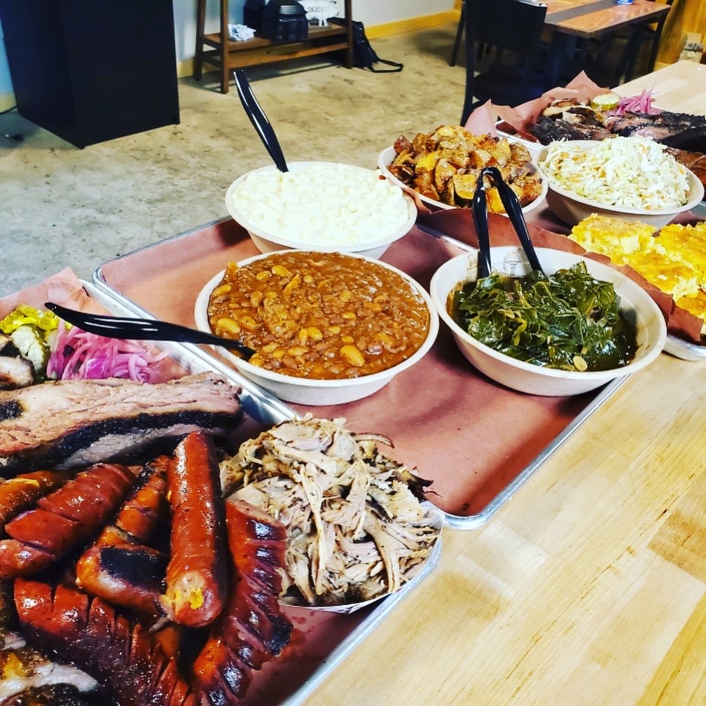 Catering spread with smoked meats and house-made sides