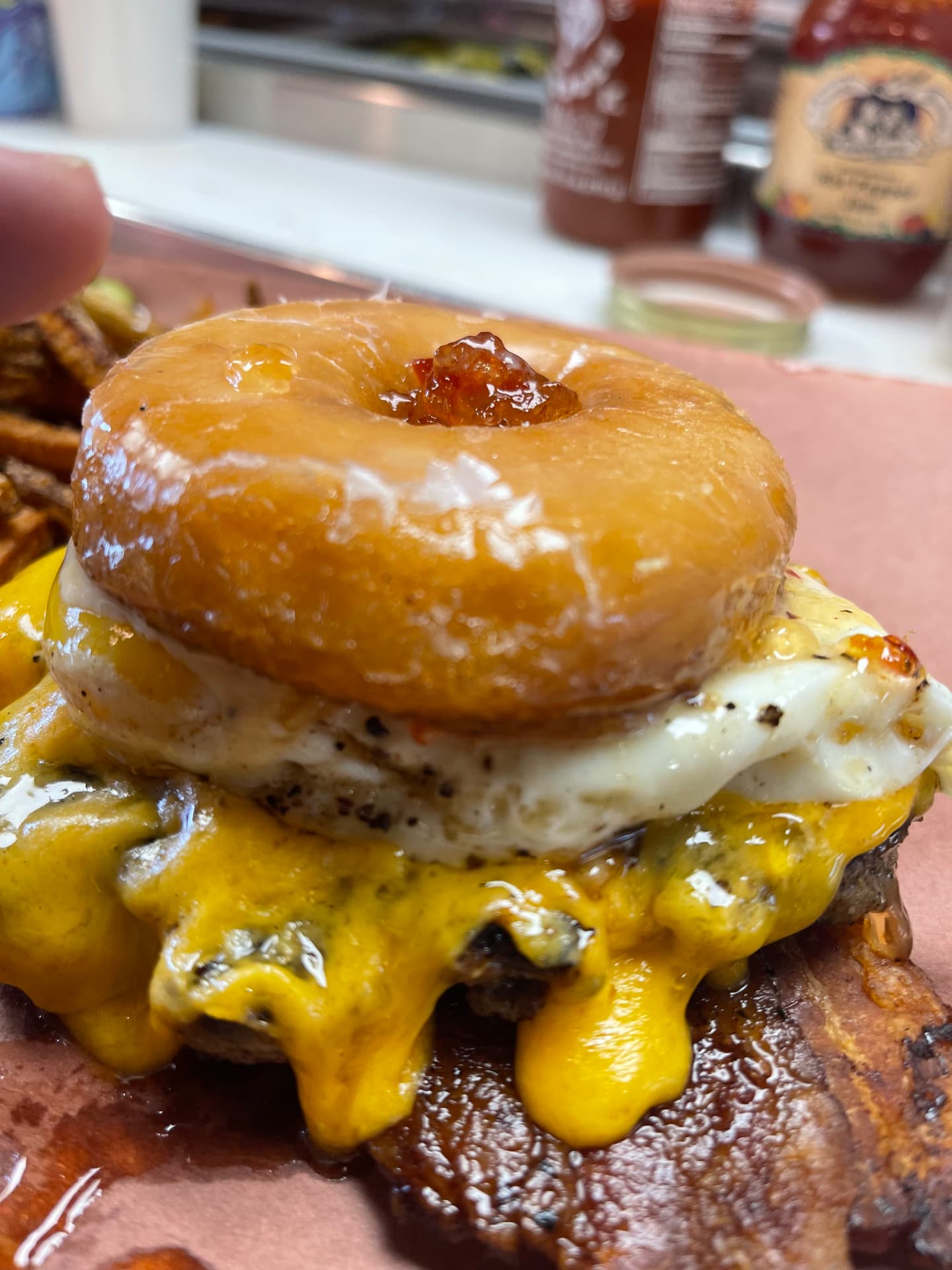 Glazed donut burger with bacon, cheddar and a fried egg